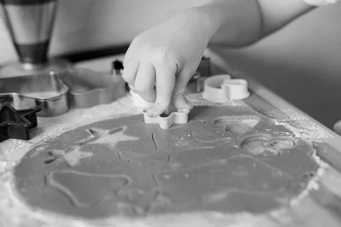 Children's hands make gingerbread. Small boy cutting cookies for Christmas. K Stock Photos
