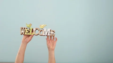 Children's hands on a mint background hold signs on the theme of spring and Stock Footage 101876220