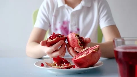 Children's hands opening a fresh pomegranate. daily life dirty stain Stock Footage 182103103