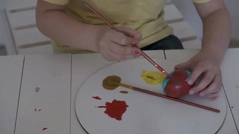 Children's hands paint Easter eggs Stock Footage 147950974