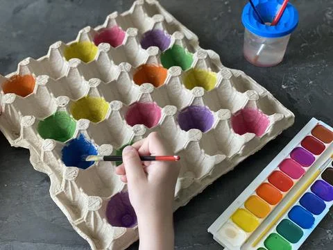 Children's hands paint the egg box, recycling, Stock Photos