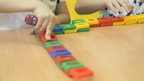 Children's hands play with colored blocks Stockbeeldmateriaal 80470143