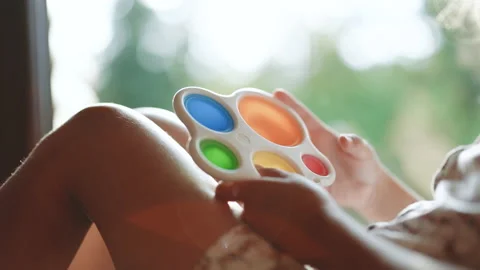 Children's hands play with the pop it simple dimple popit fidget toy. Touch bear Video stock 194747767