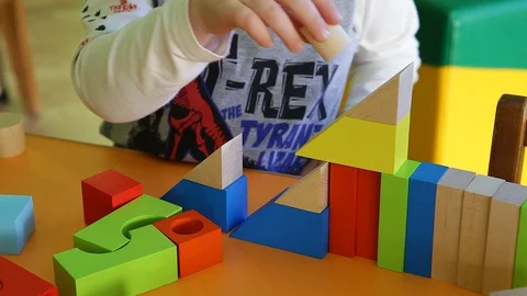 Children's hands playing a game at the table.The child plays in colored figures. Stock Footage 129813285