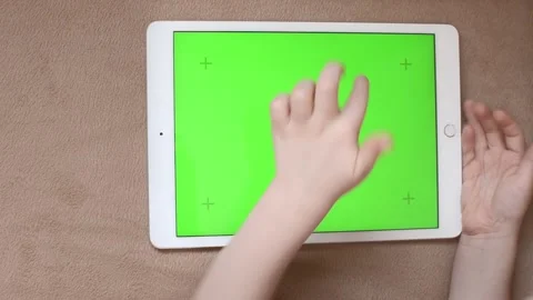 Children's hands playing on tablet green screen Stock Footage 172537998