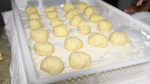 Children's hands put dough balls on a stand to make Italian panzerotti pies Stock Footage 139924169