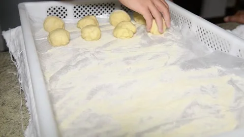 Children's hands put dough balls on a stand to make Italian panzerotti Stock Footage 139924201