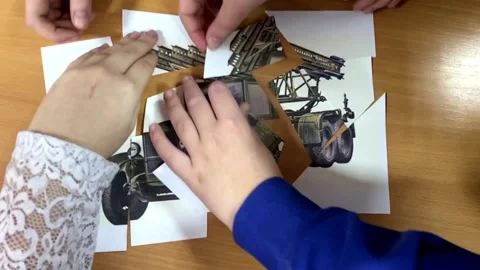 Children's hands put together a puzzle of fragments weapons katyusha Stock Footage 171243979