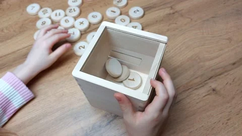 Children's hands put tokens with odd numbers in the sorter. Teaching mathematics Stock Footage 239564714