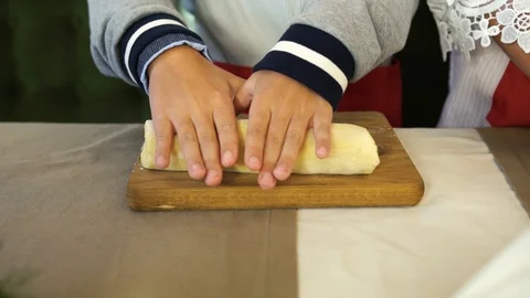 Children's hands roll out the dough Stock Footage 123650997