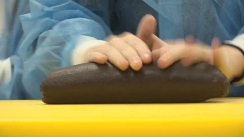 Childrens hands rolling out dough Stock Footage 310884696