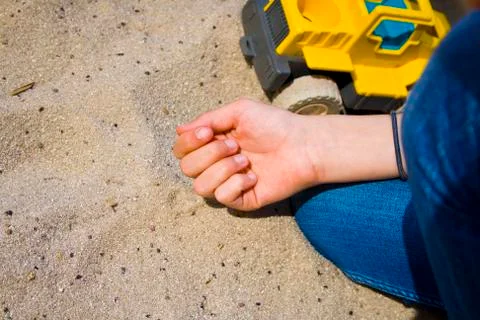 Children's hands in the sand while playing. Stock Photos