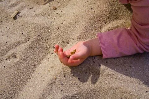Children's hands in the sand while playing. Stock Photos