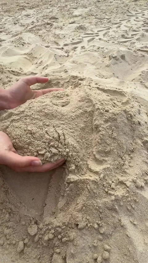 Children's hands scooping sand on the beach, building a sandcastle with creat Video stock 303358915