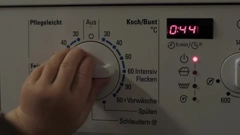 Childrens hands select the program on the washing machine Video stock 322681479