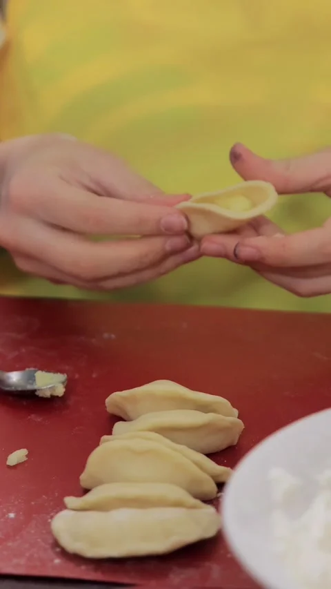 Children's hands show cooked ravioli Stock Footage 304160896