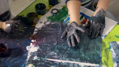 Children's hands smeared with paint draw on the paper, close-up. Stock Footage 167966221