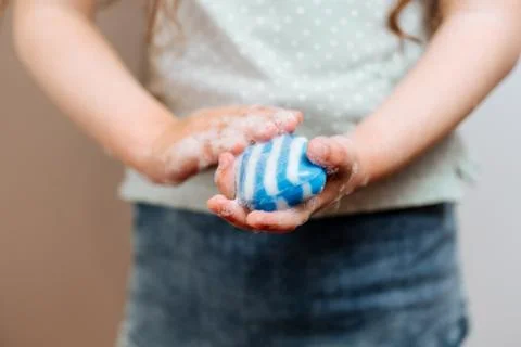 Children's hands in soapy foam Stock Photos