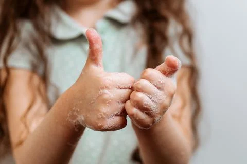 Children's hands in soapy foam. Stock Photos