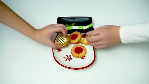 Children's hands taking biscuits from Christmas plate. Stock Footage 295116376