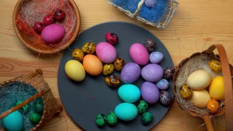 Children's hands taking colored quail Easter eggs Stock Footage 306461206