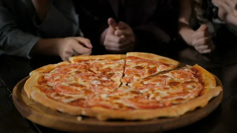 Children's hands taking pizza slices from wooden table Stock Footage 99392016