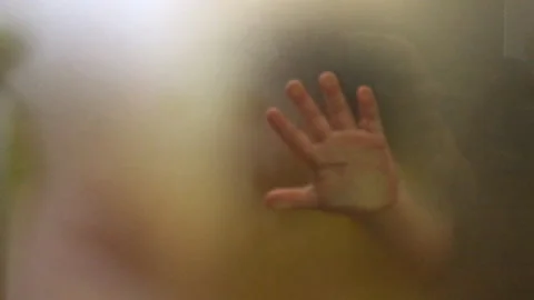 Children's hands touch frosted translucent glass Stock Footage 207682429