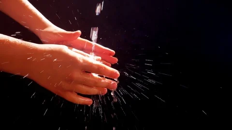 Children's hands under a stream of water. Solar spray. The child washes his Stock Footage 127205040