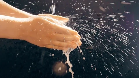 Children's hands under a stream of water. Solar spray. The child washes his Stock Footage 127206342