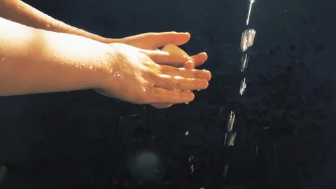 Children's hands under a stream of water. Solar spray. The child washes his Stock-Footage 127206583