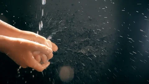 Children's hands under a stream of water. Solar spray. The child washes his Stock Footage 127206779