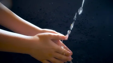 Children's hands under a stream of water. Solar spray. The child washes his Stock Footage 127207014