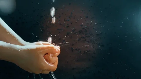 Children's hands under a stream of water. Solar spray. The child washes his Stock Footage 127207186