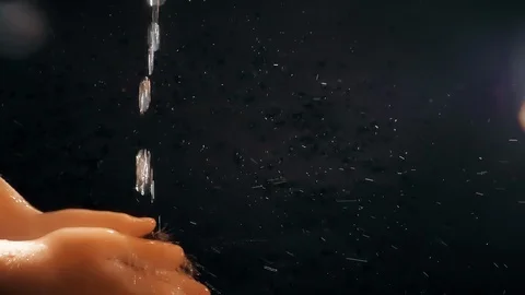 Children's hands under a stream of water. Solar spray. The child washes his Stock Footage 127207351
