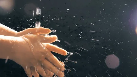 Children's hands under a stream of water. Solar spray. The child washes his Stock Footage 127207710