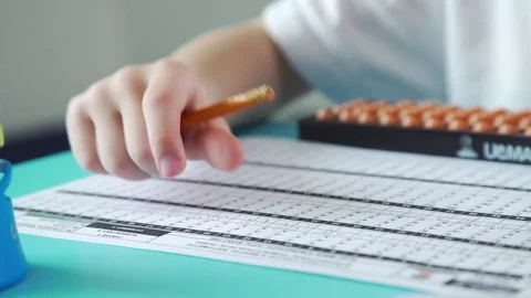 Children's hands write with a pencil and use accounts of Abakus Video stock 79522896