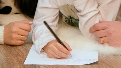 Children's hands write on a piece of paper. Stock-Footage 95272568