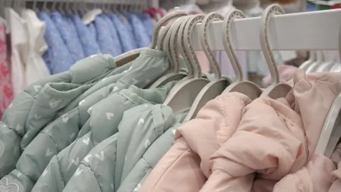 Children's jackets on hangers in a store. 스톡 동영상 265926307