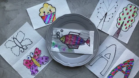 Children's magic experience, children's hands put the drawing in a plate Stock Footage 140256089
