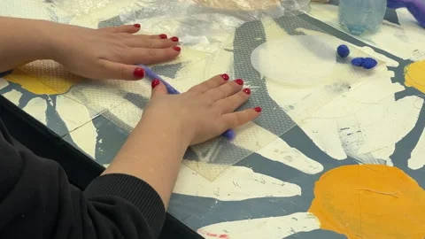 Children's master class on felting a toy, children twist wool on the table Stock Footage 306569293
