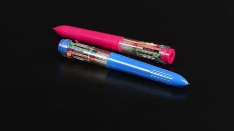 Children's multi-colored pen on a black background. Stock Footage 221126222