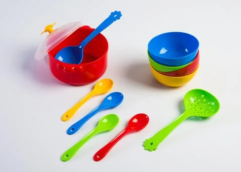 Children's multi-colored plastic toy tableware on a white background. Foto stock