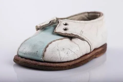 Children's old shoe on a white background Stock Photos
