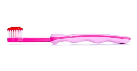 Children's pink toothbrush with toothpaste Stock Photos
