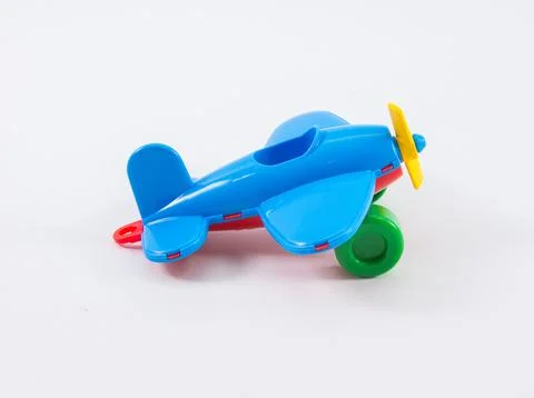Children's plastic multi-colored airplane on a white background. Foto stock