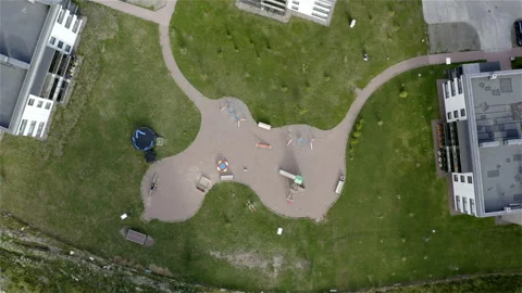 Children's play area with playgrounds between houses Stock Footage 115147364