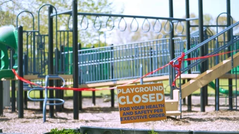 Children's playground closed off with red caution tape Video stock 129469071
