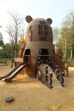 A children's playground in the shape of a bear, made of wood with metal acc.. Stock Photos