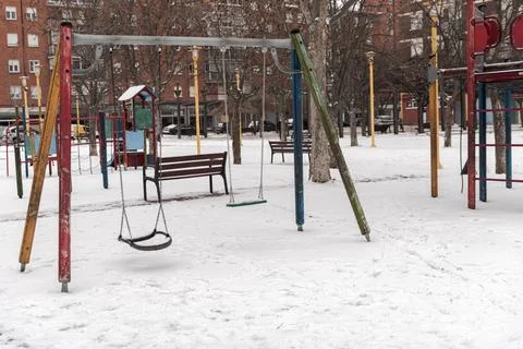 Children's playgrounds empty and snow covered after a historic snowfall Stock Photos