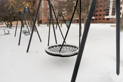 Children's playgrounds empty and snow covered after a historic snowfall Stock Photos